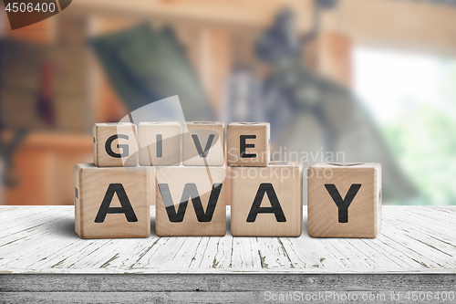 Image of Give away contest sign on a wooden desk 