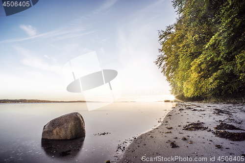 Image of Rock in the calm water on a nordic beach