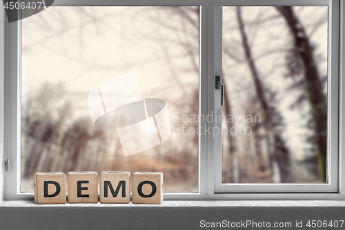 Image of Demo sign in a window with a view to a forest