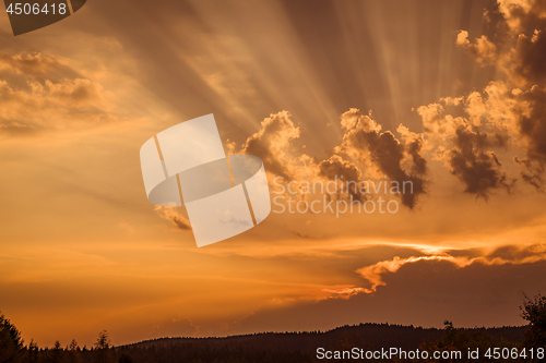 Image of Sunset with rays lighten up the clouds