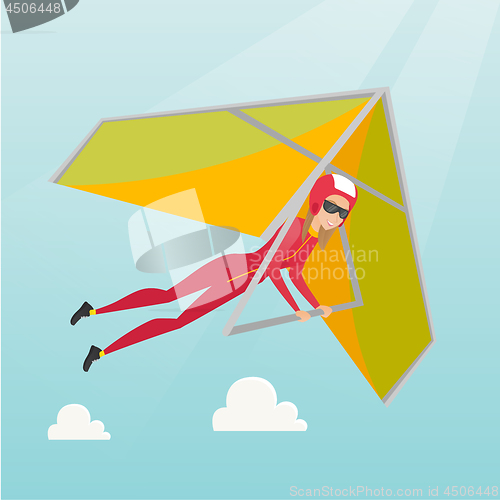 Image of Young caucasian woman flying on hang-glider.
