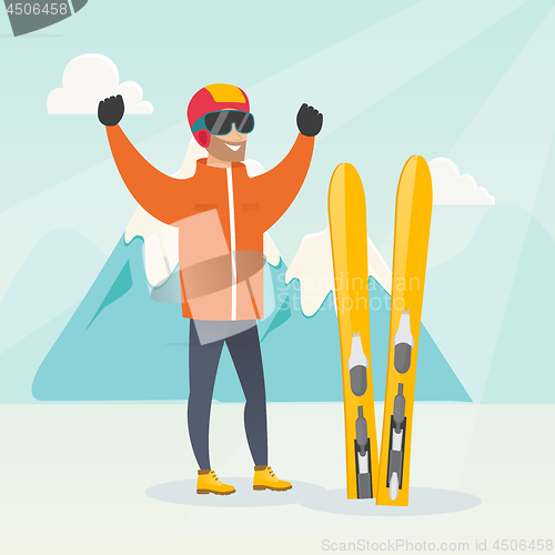 Image of Young caucasian skier standing with raised hands.