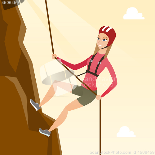 Image of Caucasian woman climbing a mountain with rope.