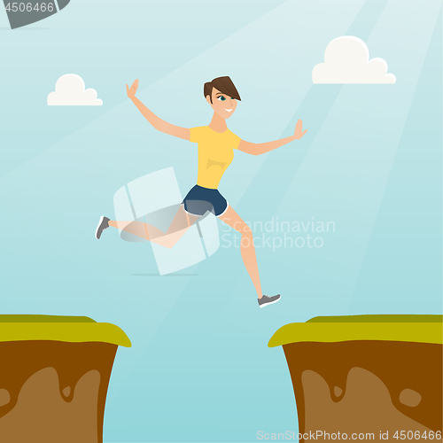 Image of Young caucasian sportswoman jumping over the cliff