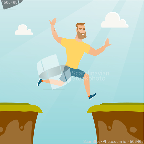 Image of Young caucasian sportsman jumping over the cliff.
