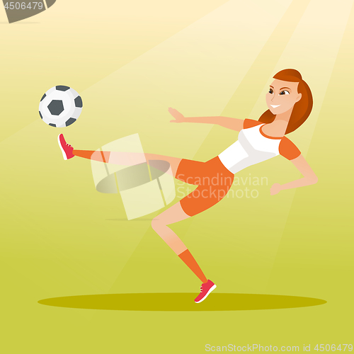 Image of Young caucasian soccer player kicking a ball.