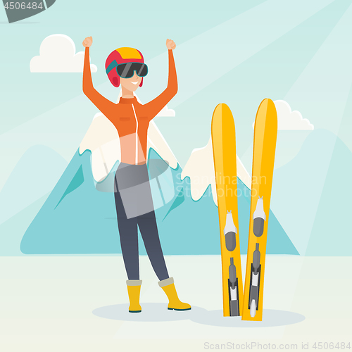 Image of Young caucasian skier standing with raised hands.