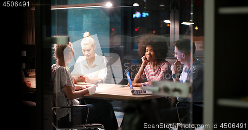 Image of Multiethnic startup business team in night office