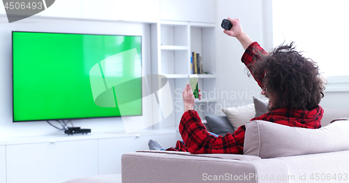 Image of Young couple on the sofa watching television