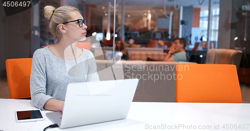 Image of businesswoman using a laptop in startup office