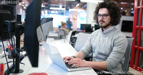 Image of businessman working using a laptop in startup office