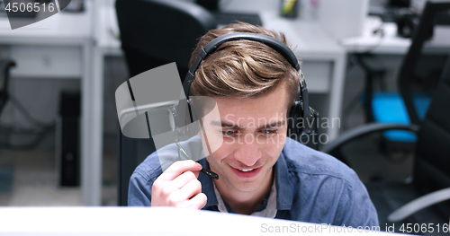 Image of male call centre operator doing his job