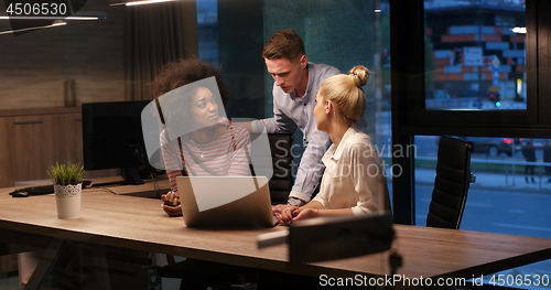 Image of Multiethnic startup business team in night office