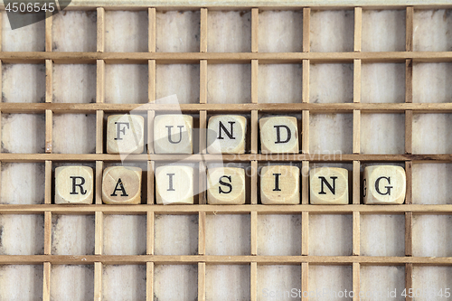 Image of Fund raising sign made of dices on a dirty shelf