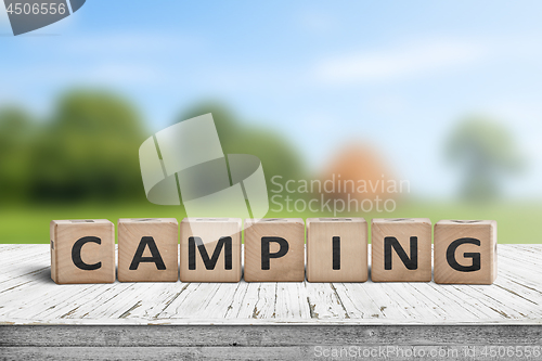 Image of Camping word on a wooden cube sign