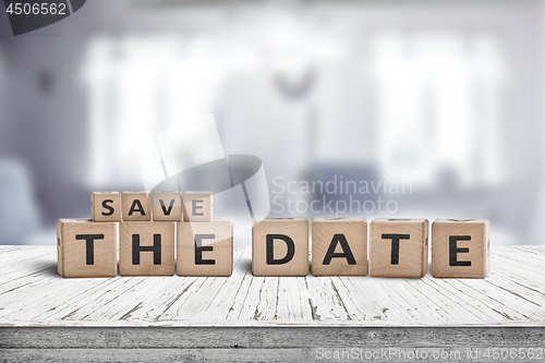 Image of Save the date memo sign on a wooden table