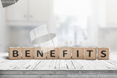 Image of Benefits on a worn table in a bright room