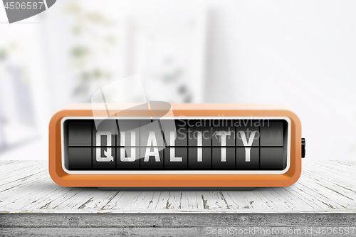 Image of Retro device with the word quality displayed