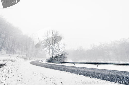 Image of Curvy highway in a misty winter landscape