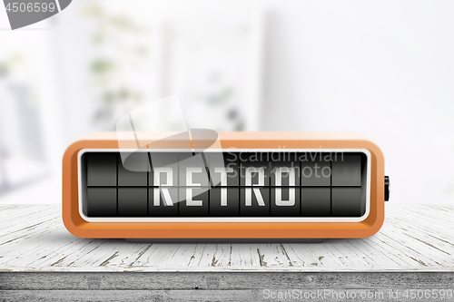 Image of Retro alarm clock with a message on a wooden table