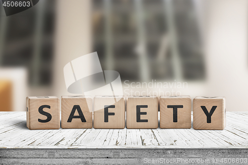 Image of Safety sign on a wooden desk in a room