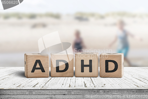 Image of ADHD sign on a wooden table with kids