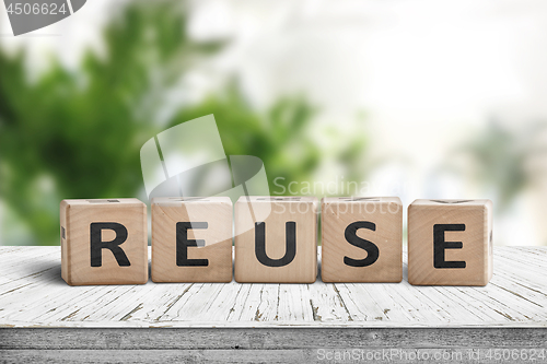 Image of Reuse sign on a wooden table in a room
