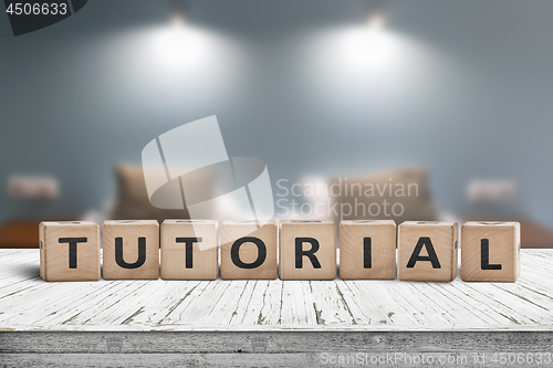 Image of Tutorial sign on a wooden table in a room with lights