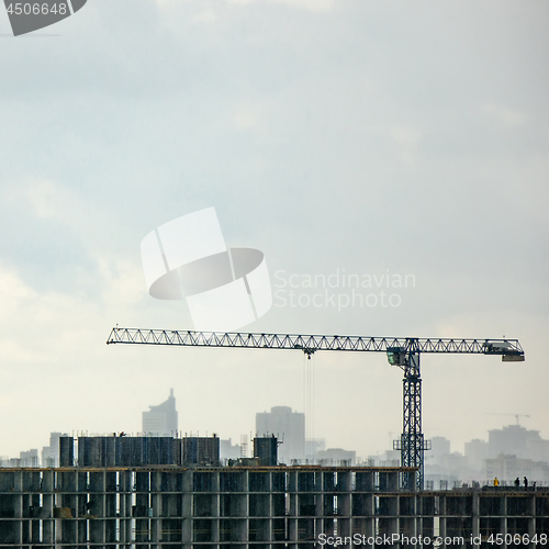 Image of Panoramic photo from the drone of building under construction with crane against a cloudy sky.