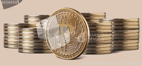 Image of Single bitcoin coin standing in front of stacks of coins