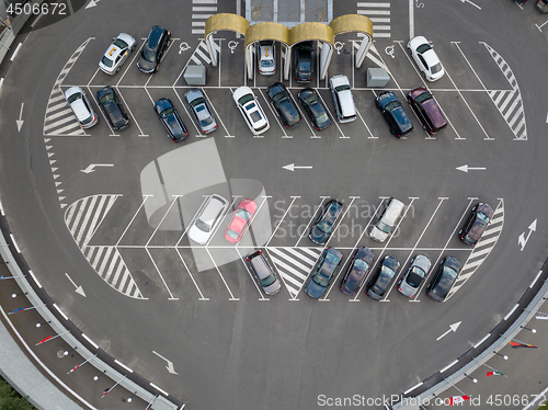 Image of Birds eye view from the drone is strictly above the parking with cars.