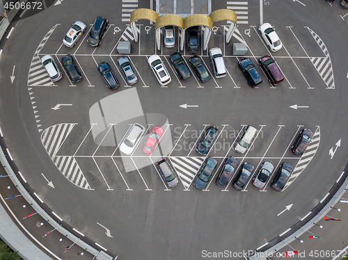 Image of Birds eye view from the drone is strictly above the parking with cars.
