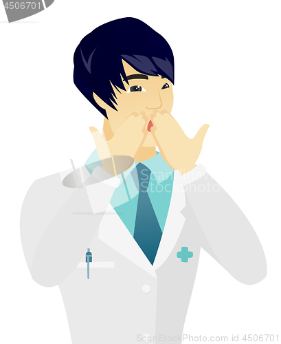 Image of Shoked asian doctor covering his mouth.