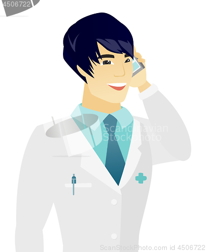 Image of Young asian doctor talking on a mobile phone.