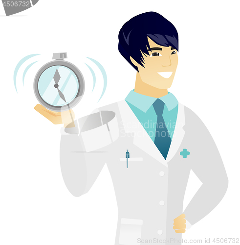 Image of Young asian doctor holding alarm clock.