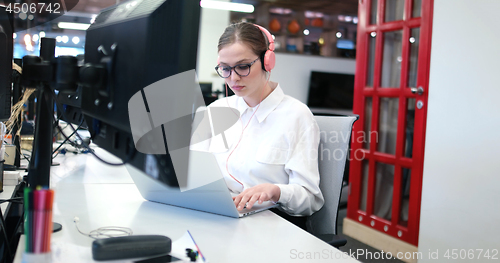 Image of businesswoman using a laptop in startup office