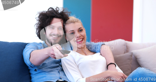 Image of Young couple on the sofa watching television