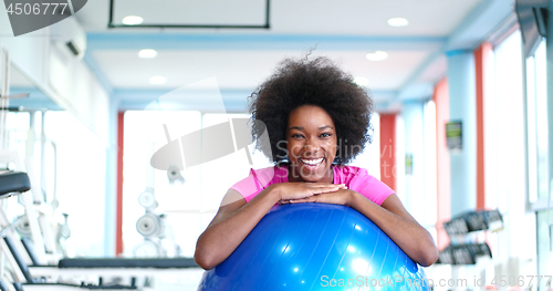 Image of portrait of young afro american woman in gym on workout break