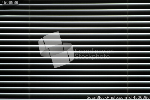 Image of Plastic closed window blinds in the room.