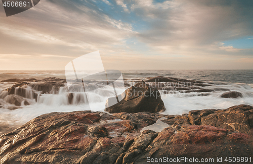 Image of Sunlight hitting the rocks with ocean waterfall cascades