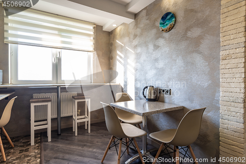 Image of Fragment of the kitchen interior, with a dining table