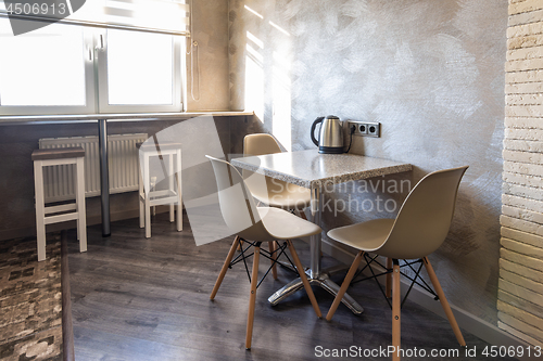 Image of A table with chairs in the interior of the kitchen