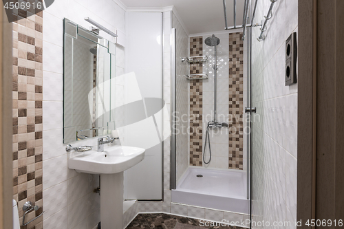 Image of The interior of a small bathroom with shower