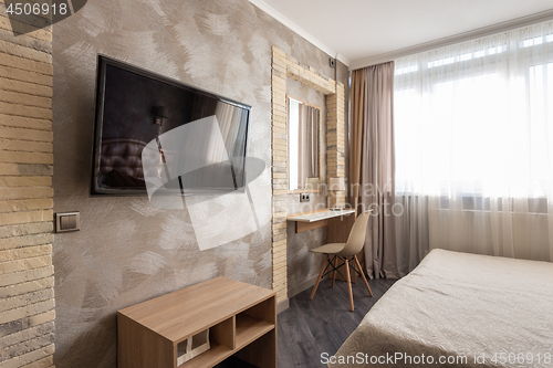 Image of Interior of a bedroom, a fragment with a TV and a dressing table