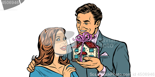 Image of Husband and wife. House as a gift isolate on white background