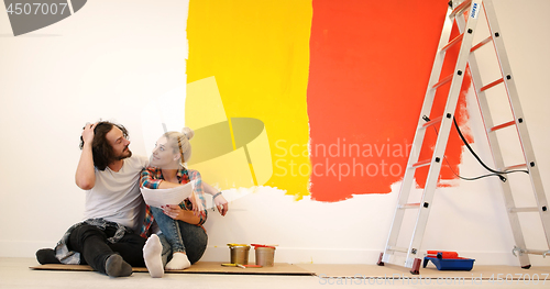 Image of Happy young couple relaxing after painting