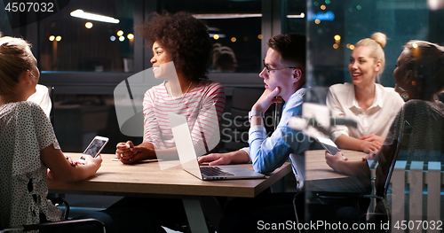 Image of Multiethnic startup business team in night office