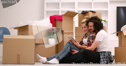 Image of young couple moving  in new house