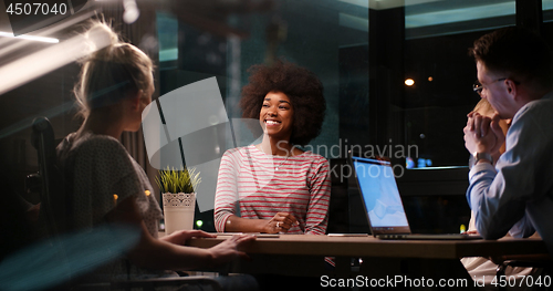 Image of Multiethnic startup business team in night office