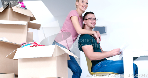 Image of Young couple moving in a new home